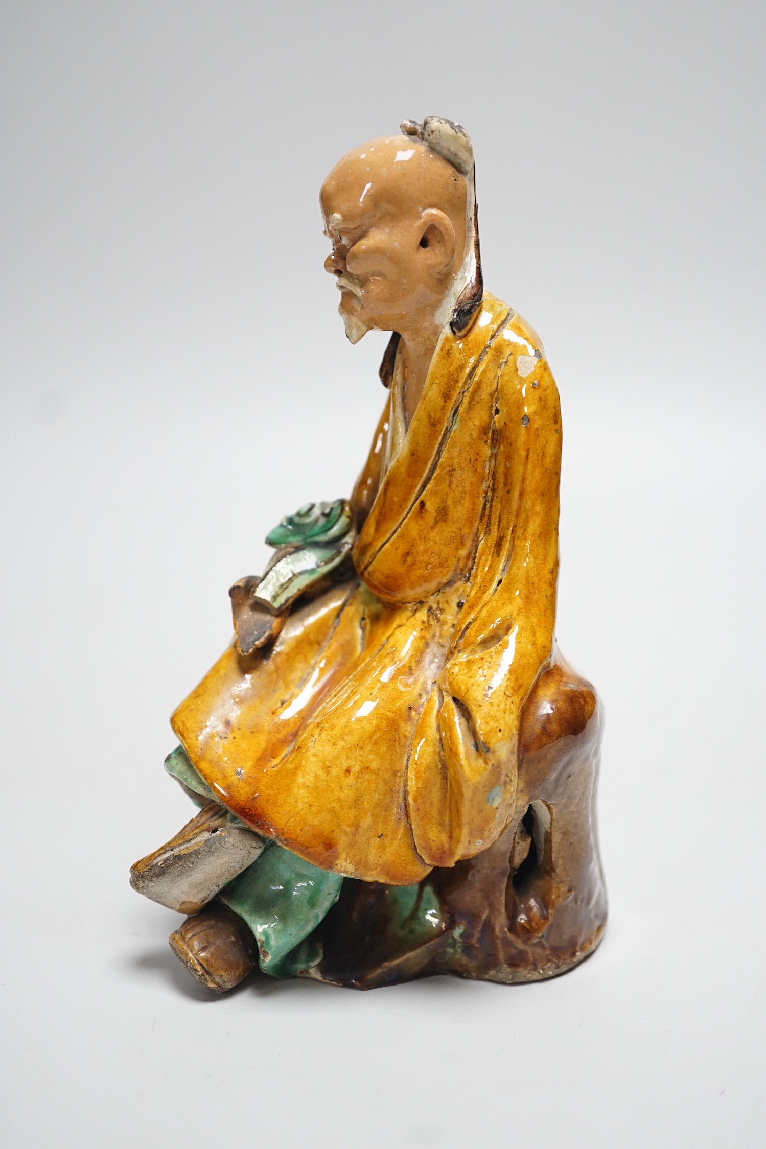 A Chinese Shiwan figure of a sage, possibly 18th century, 19cms high